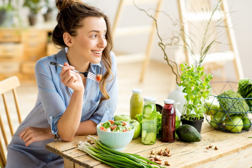 Woman eating healthy salad Woman eating vegetables