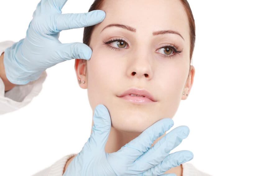 61 Doctor's hand inspecting a female patient's face