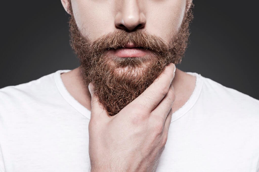 Man holding his beard