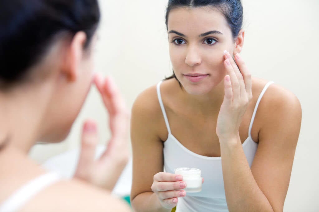 80-1024×683 Woman applying skin care to her face