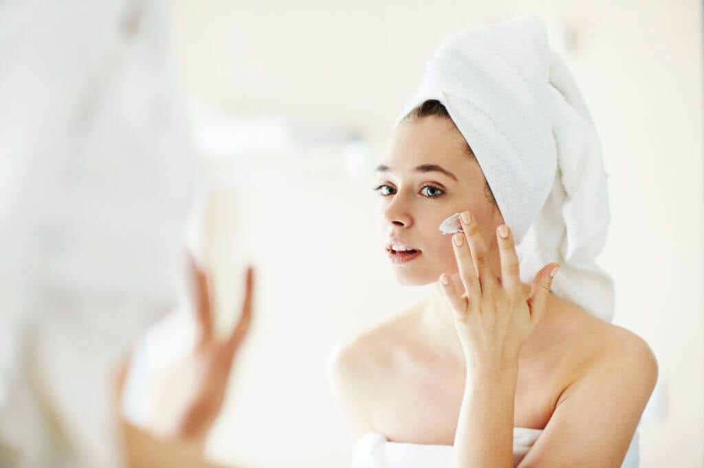90-1024×682 Woman applying skin care to her face