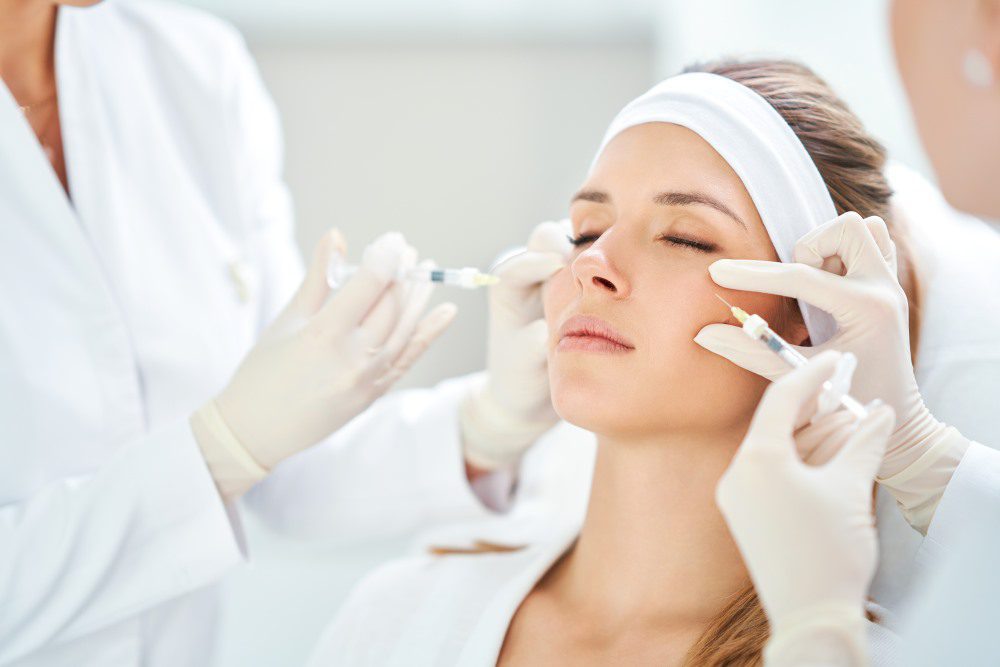 BotoxCombinationYLSC A woman receiving multiple cosmetic treatments at a medical spa.