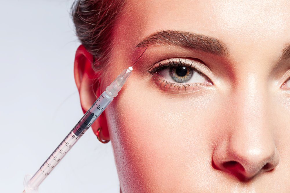 BotoxFutureTrendsYLSC Close-up of a woman doing an injection under the eyebrow.