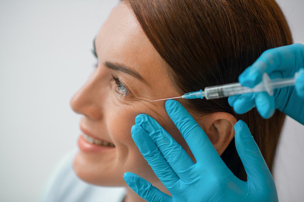 BotoxGuideFAQsYLSC A woman receiving Botox injections to help smooth wrinkles around eyes.
