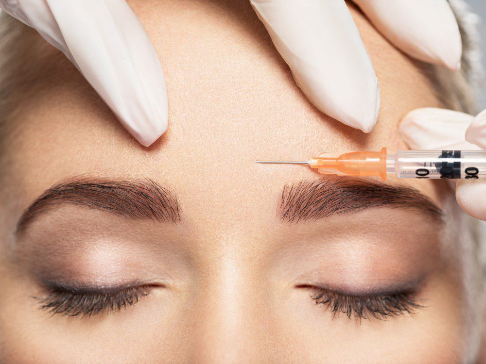 BotoxUnitsYLSC Woman getting cosmetic injection of botox near eyes