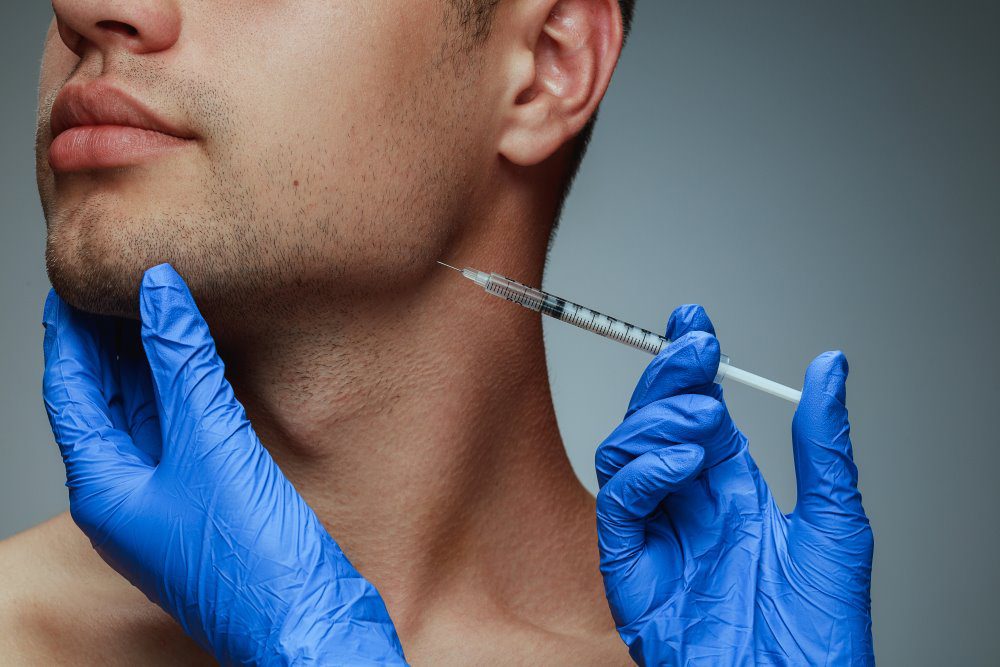 BotoxforMenYLSC A man receiving Botox near the jawline by a clinician.