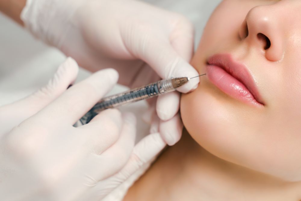 JuvedermLipFillerYLSC A woman receiving a Juvederm lip filler treatment.