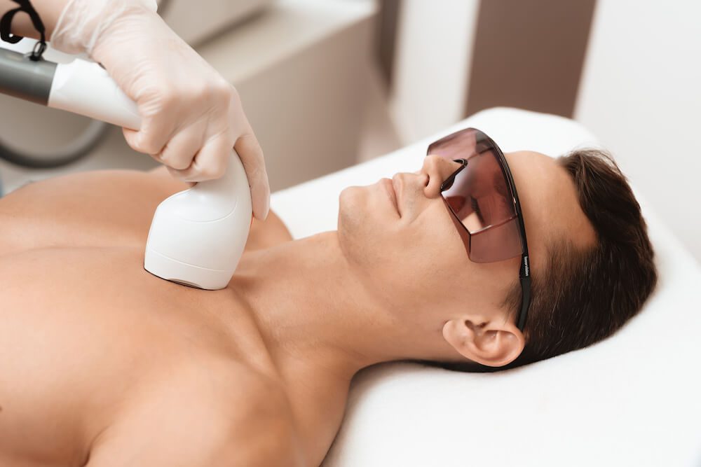 Permanent or Temporary Fix? What To Know About Laser Hair Removal Treatment man getting laser hair removal on his chest with led blocking glasses