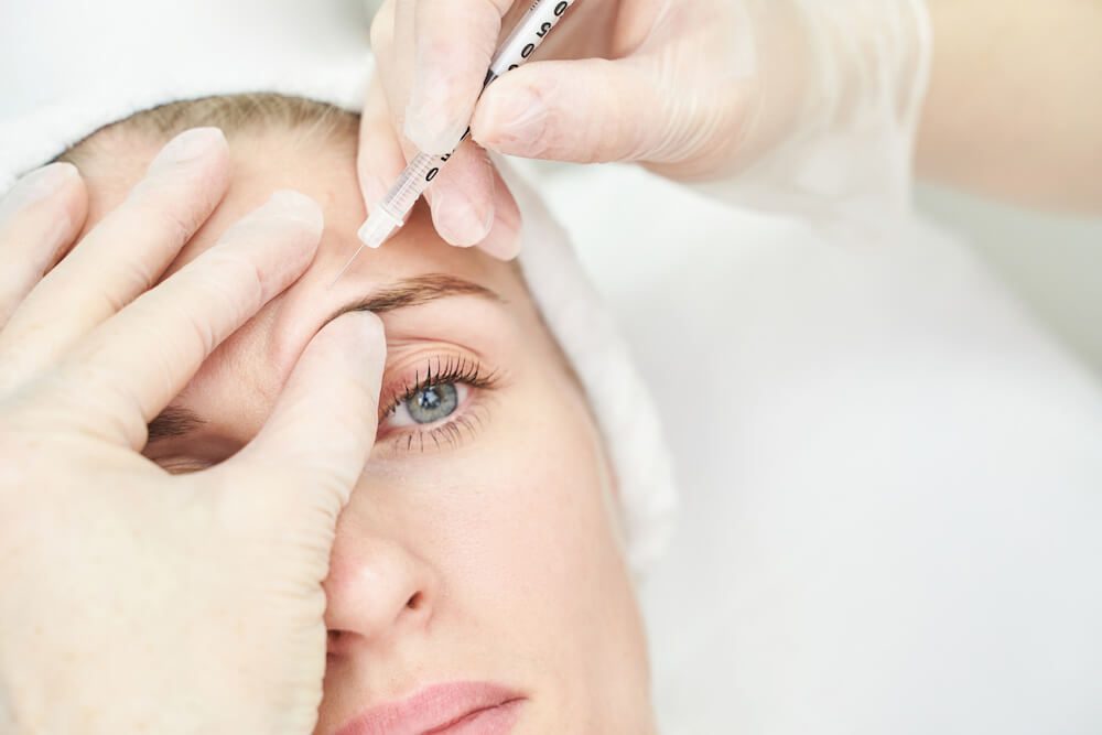 What Are Restylane Fillers and What Are They Best Used For? Woman getting restylane filler, closeup of the right side of her face