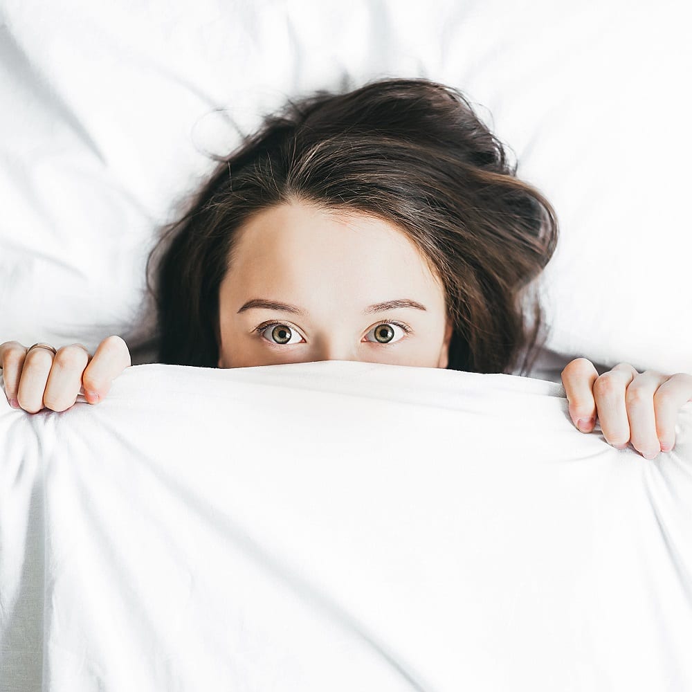 does-preventative-botox-actually-work Woman covering her half face with blanket