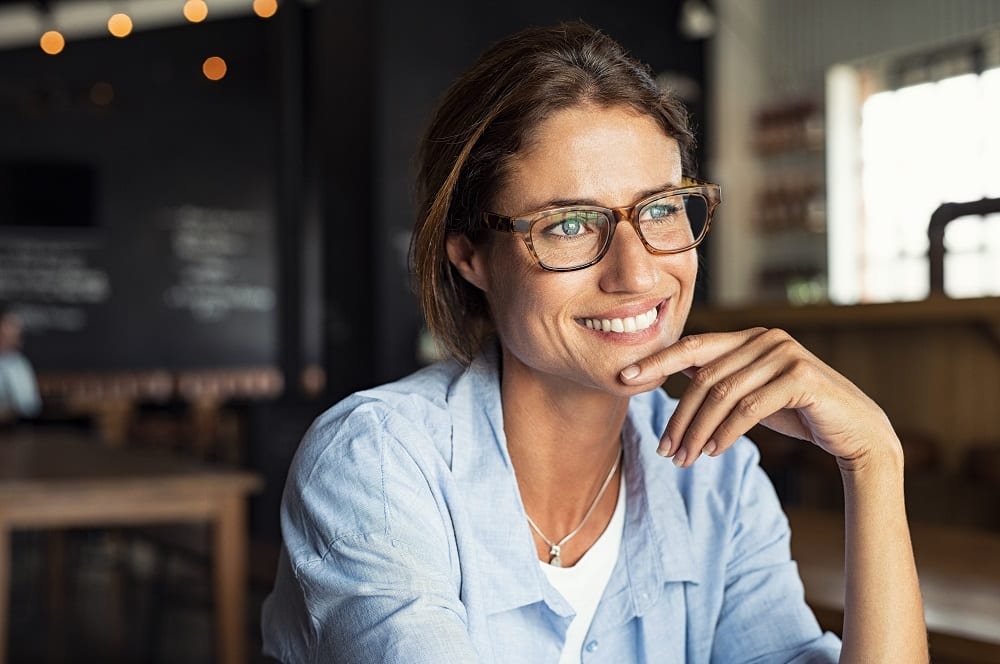 Smiling woman wearing spectacles Woman in cafe/restaurant
